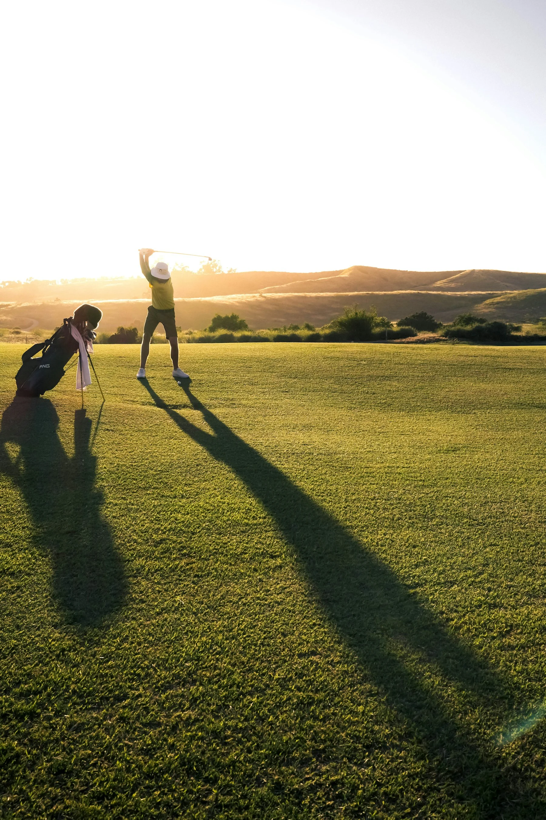 Two golfers walking up a fairway