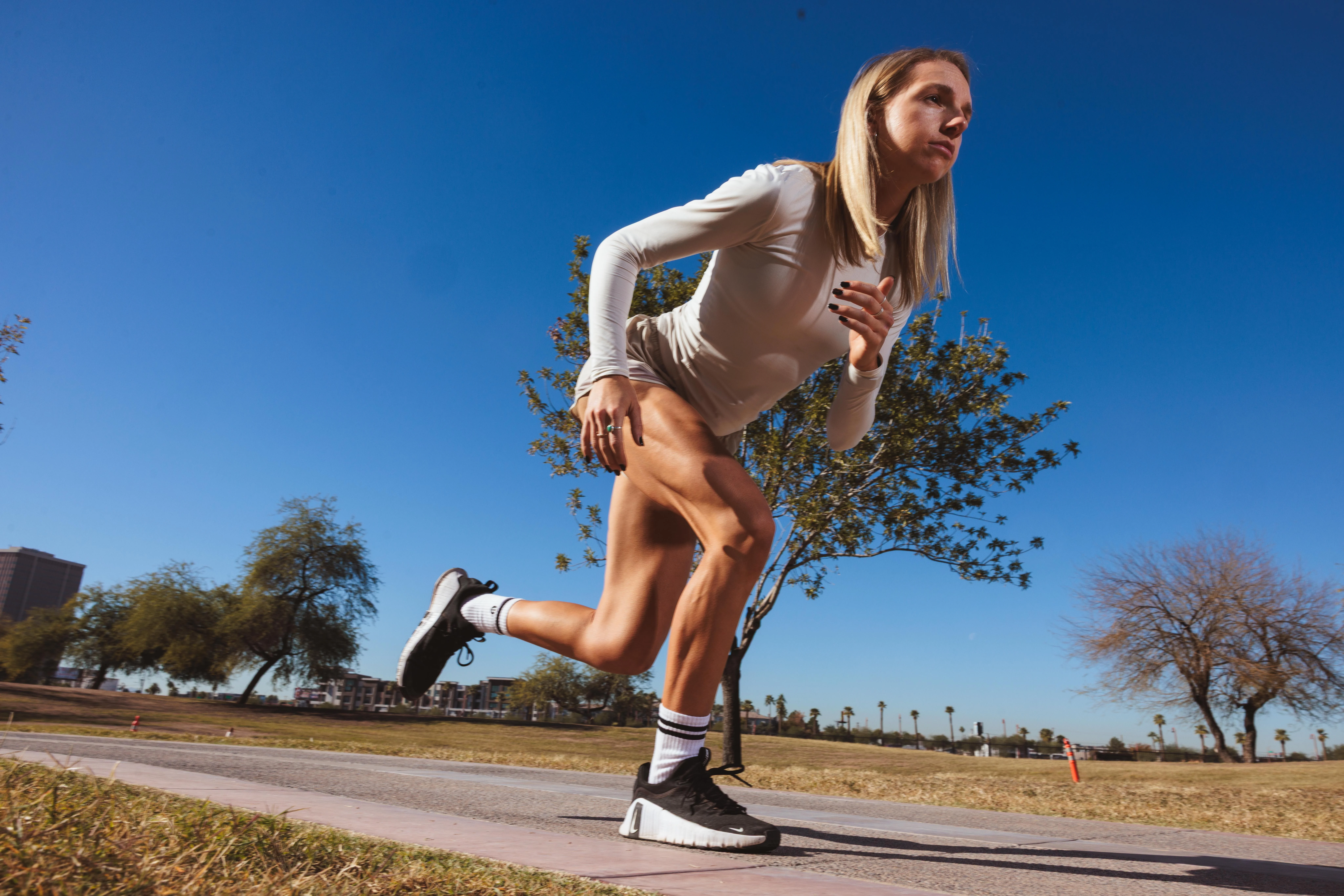 Runner mid-stride against a clear sky