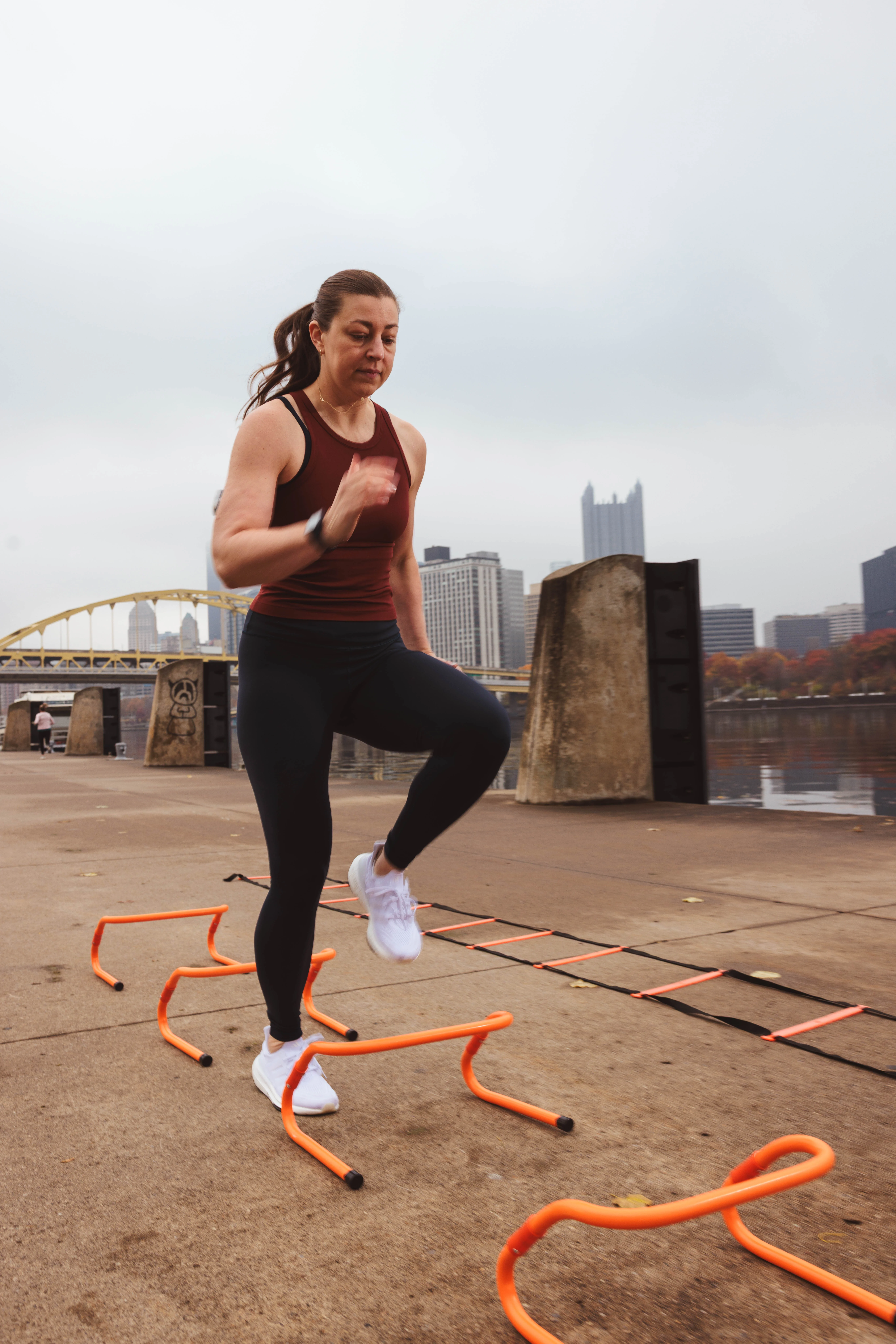 Runner doing agility hurdle drills outdoors