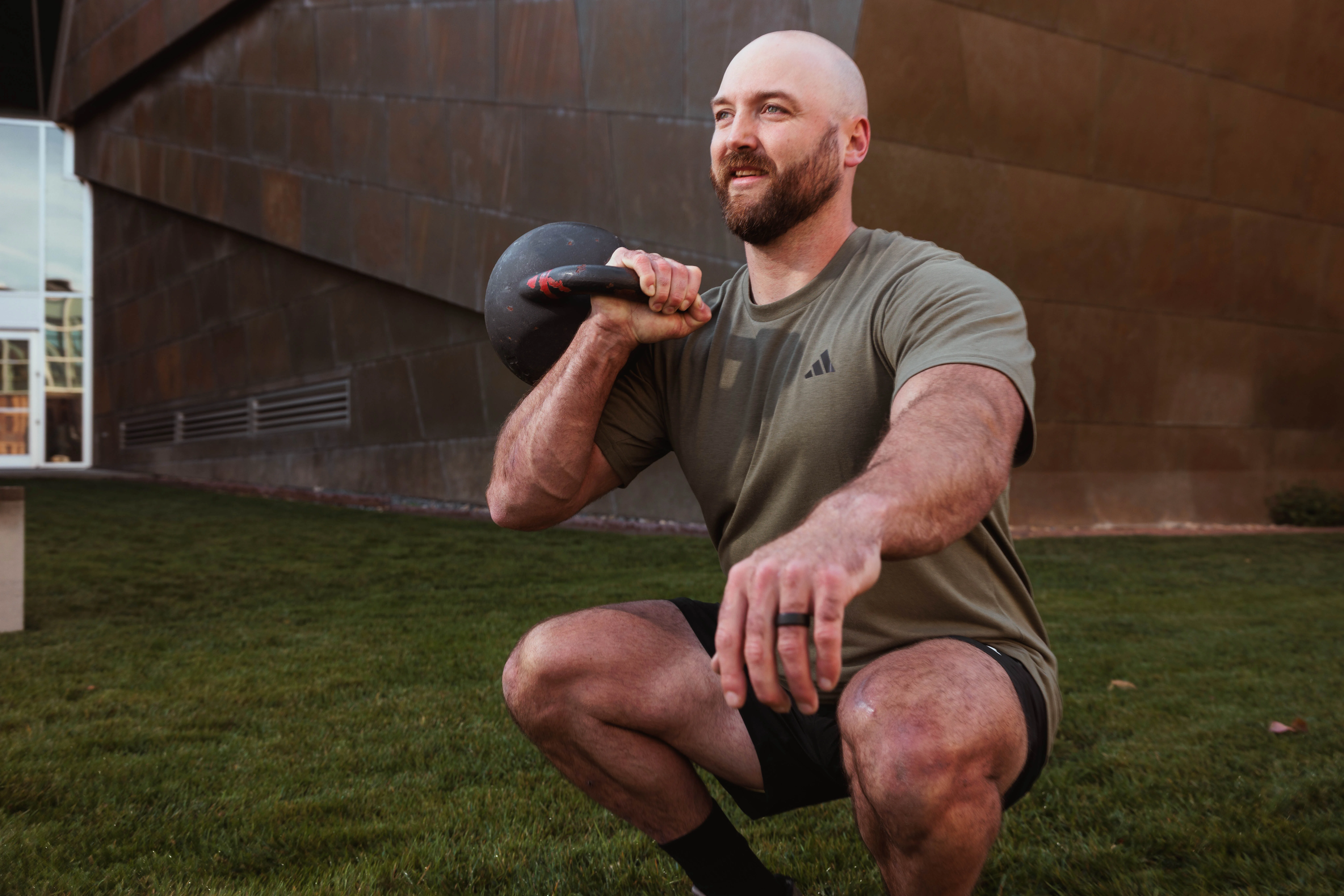 Athlete performing a kettlebell squat outdoors